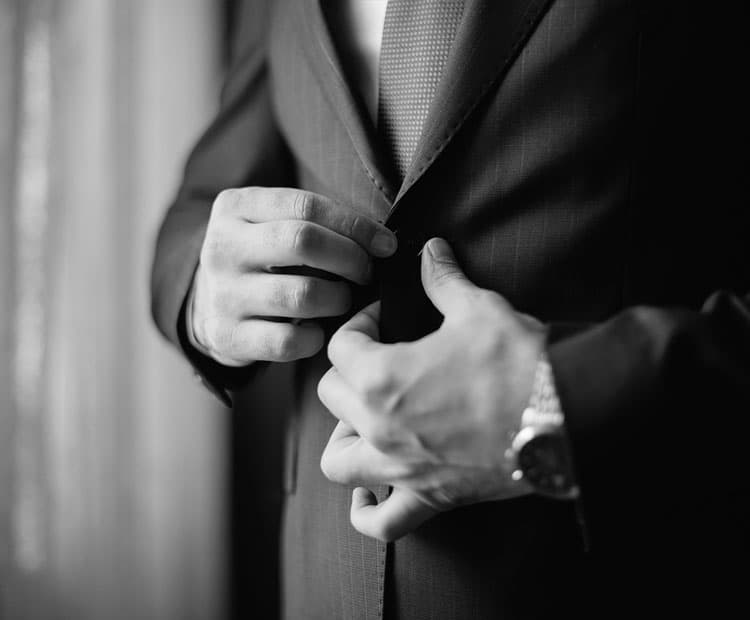 Man buttoning up suit. Black and white image