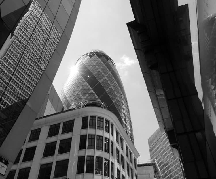 Black and white image of buildings, including Canary Wharf / The Gherkin